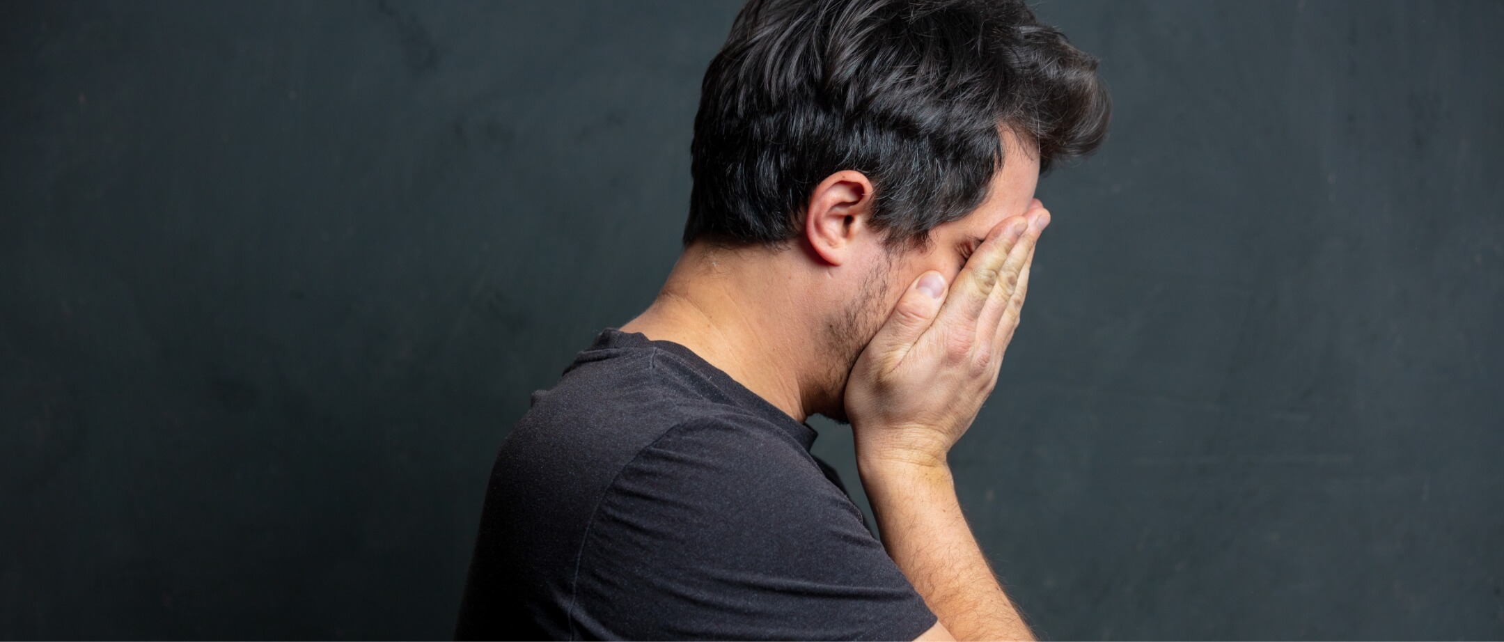 tired-brunet-man-in-black-t-shirt-on-dark-backgrou-2023-11-27-05-13-32-utc (1) (1)
