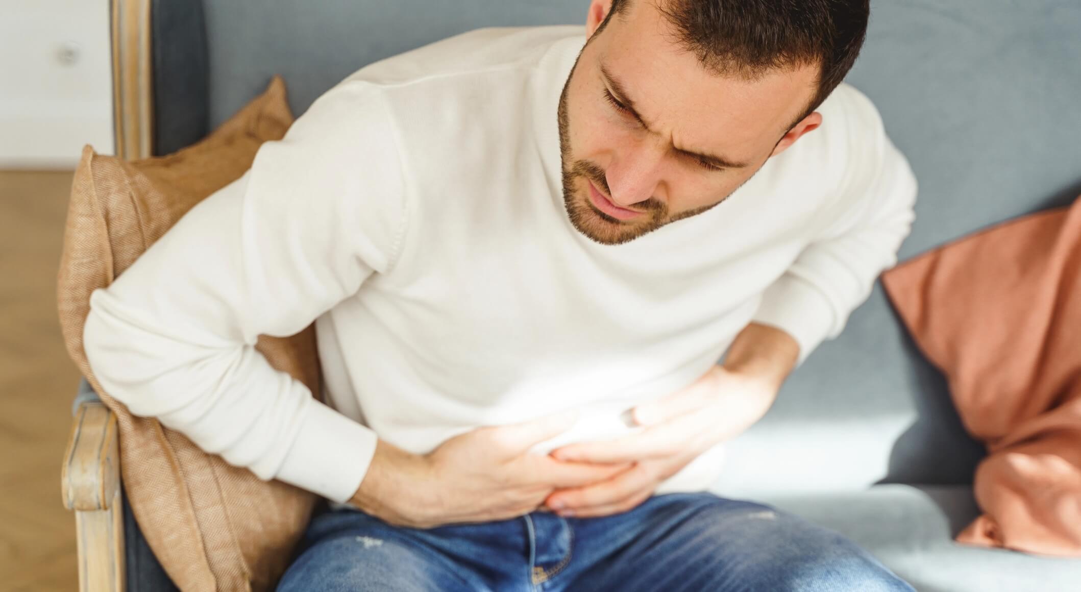 young-man-writhing-in-a-stomach-pain-2023-11-27-04-57-06-utc@2x-1