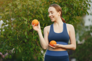 a woman holding oranges