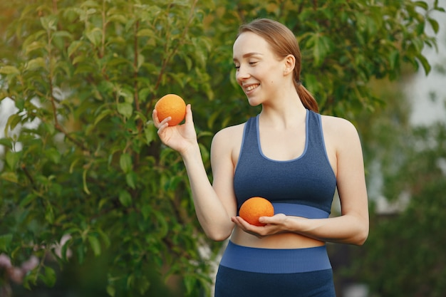 a woman holding oranges