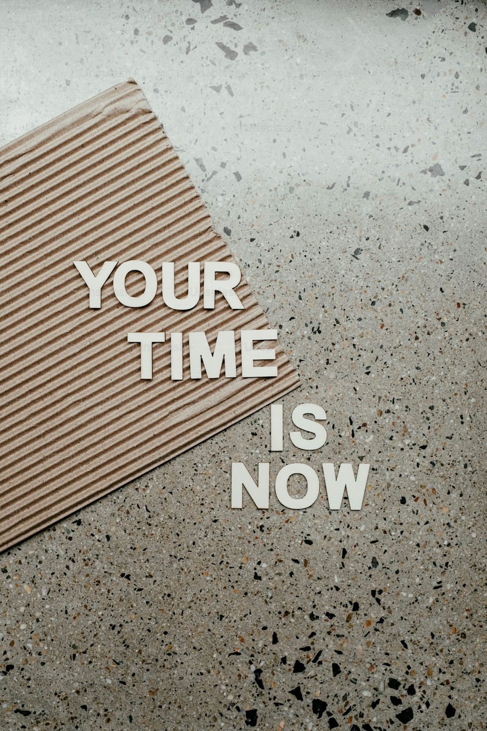 A motivational quote, "Your Time Is Now," displayed on a letter board.