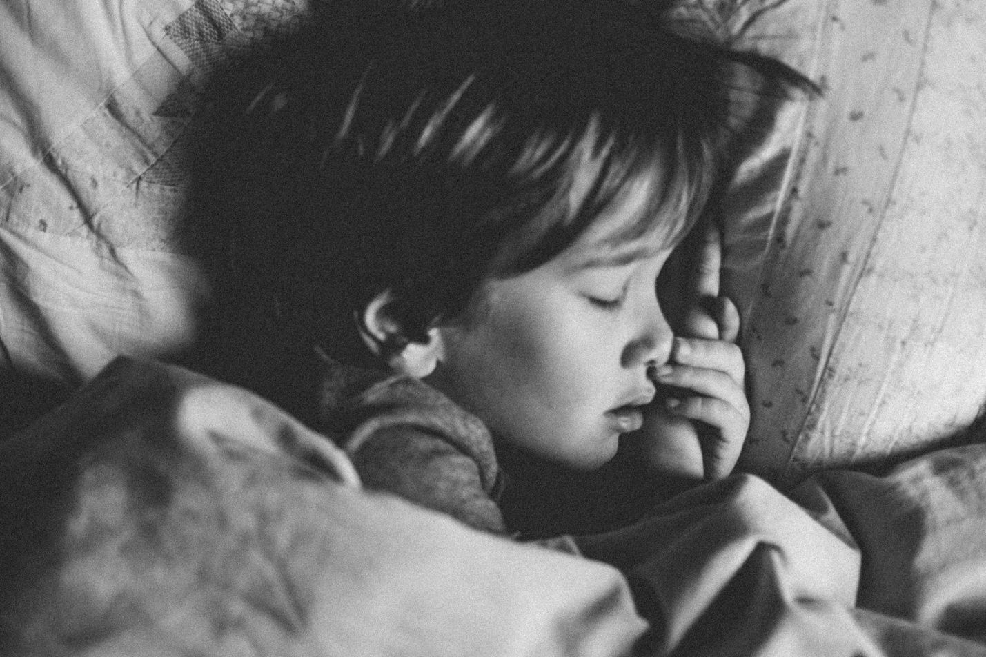 a child sleeping in bed